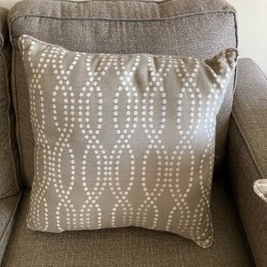 Tan and white elongated dot design pillow.